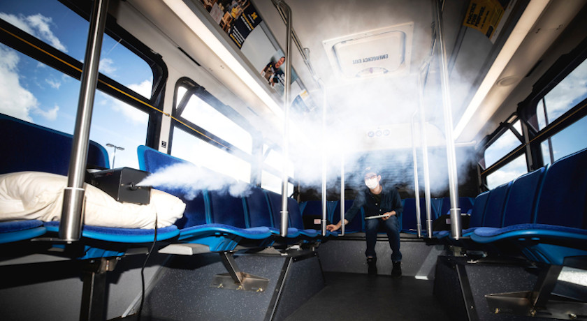 A bus is being sterilized through an antimicrobial mist