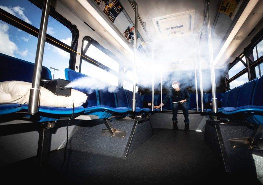 A bus is being sterilized through an antimicrobial mist