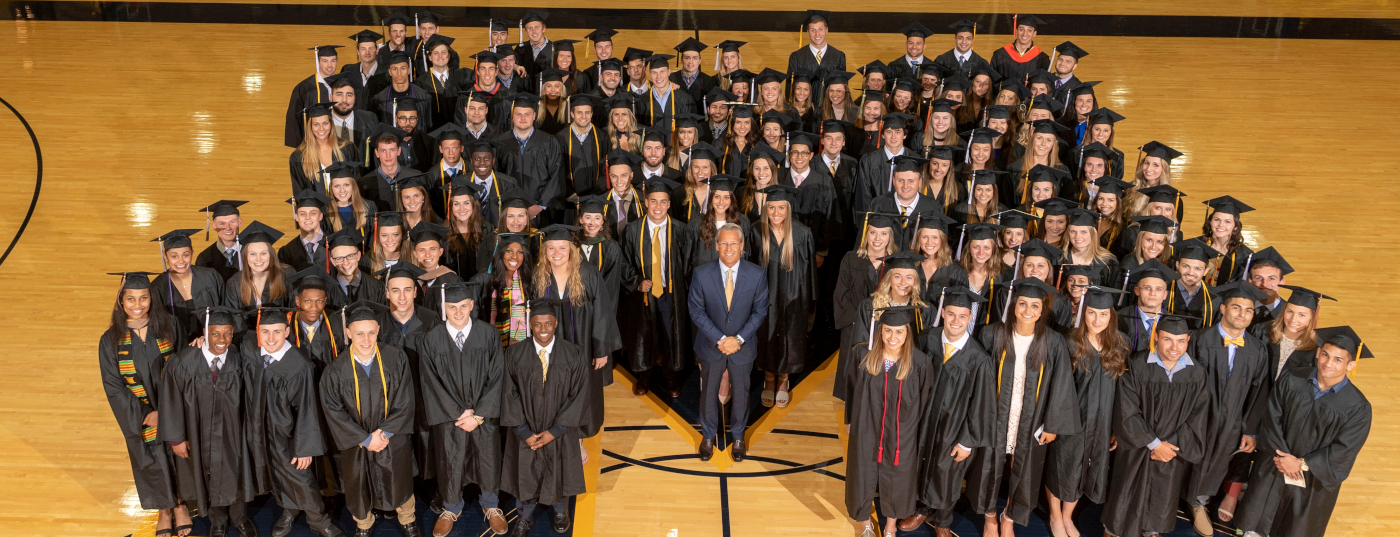 U-M graduates form a block M on the basketball courts