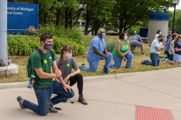 Students in face masks kneeling on commemorance of Juneteenth