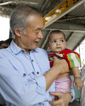 Tadataka holding a child