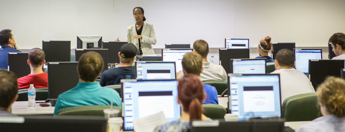 A professor lecturing in a computer lab